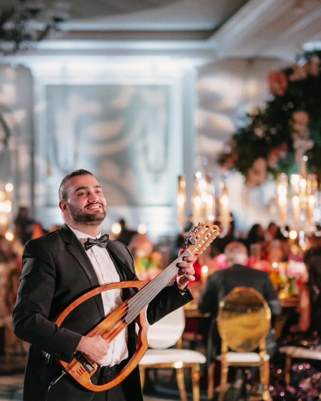 Majed performing by candlelight at a reception