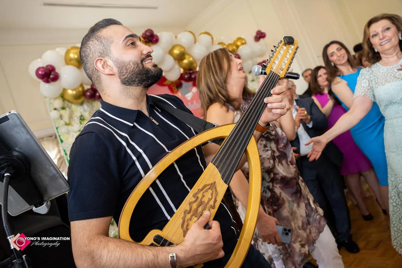 Majed playing among celebrating guests